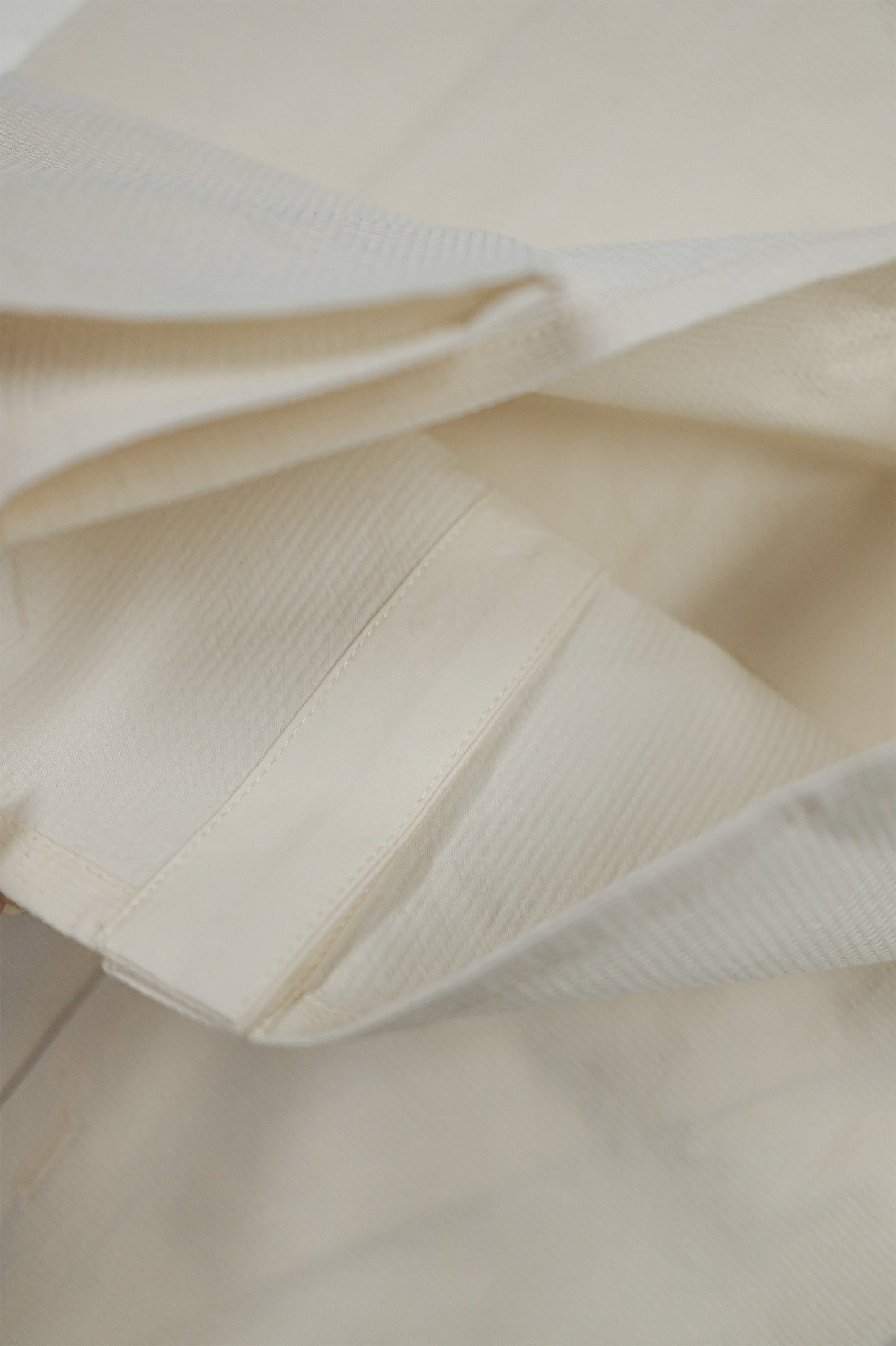 Ully Cream Diagonal Button Sleeveless top