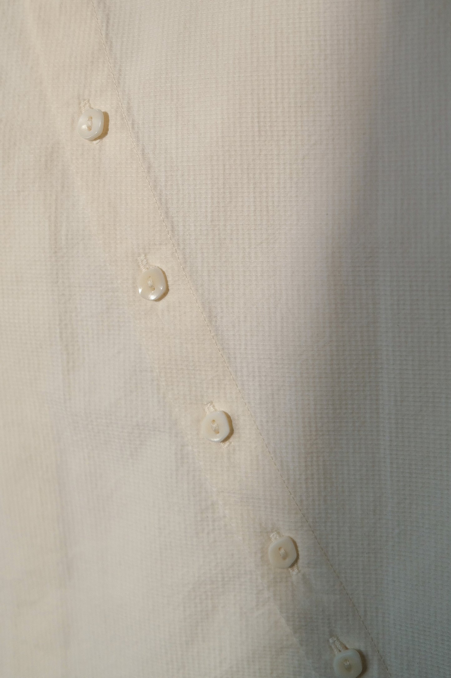 Ully Cream Diagonal Button Sleeveless top